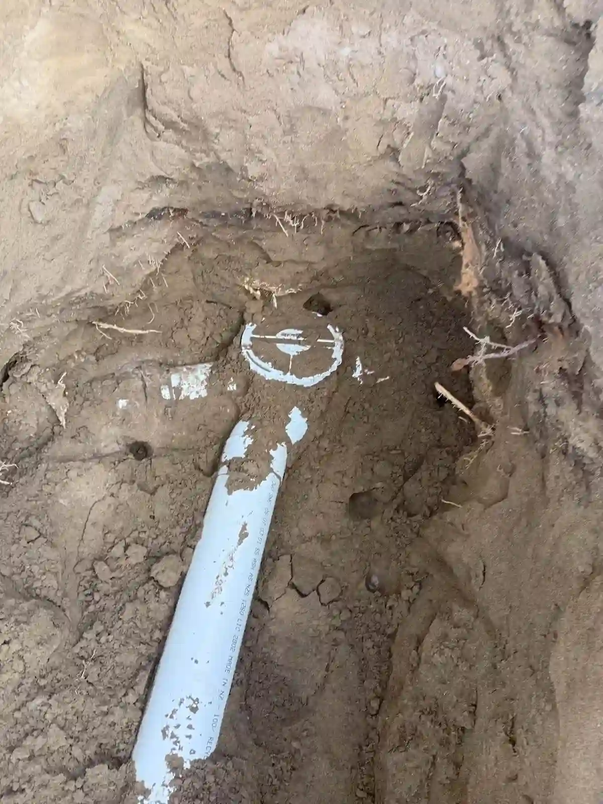 Backfilled drainage pipe photo used for Certificate of Acceptance evidence