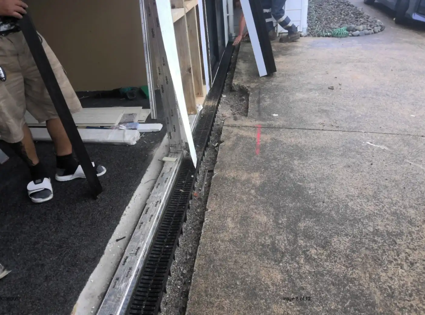 Channel drain installed outside garage conversion to manage external moisture clearances